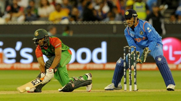 Bangladesh batsman Mahmudullah plays a shot in front of India's Mahendra Singh Dhoni during the World Cup quarter-final match that had a controversial umpiring decision at the MCG on March 19.