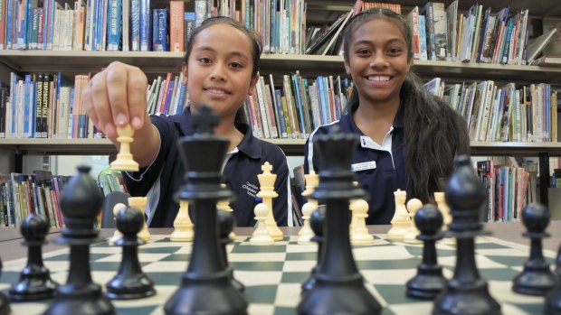 Sisters Imogen and Nicole Vea are following in their older siblings' footsteps, taking part in a national chess tournament with other students from Caroline Chisholm School.
