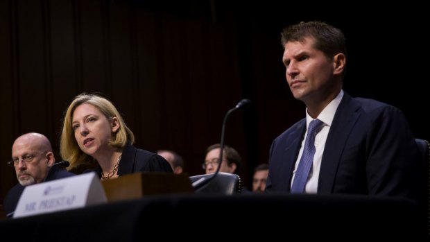 Jeanette Manfra of the Department of Homeland Security speaks while Bill Priestap, of the FBI, right, listens during a congressional hearing on sanctions against Russia.