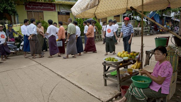 Candidates and supporters of Myanmar Opposition Leader Aung San Suu Kyi's National League of Democracy party campaign in Yangon on Tuesday.