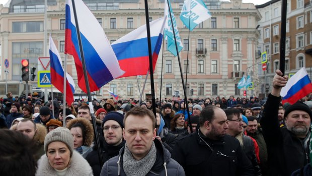 Russian opposition leader Alexei Navalny, centre, and his wife Yulia, left, take part in a march in memory of opposition leader Boris Nemtsov in Moscow.