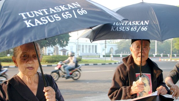 Sumini, left, and Anwar Umar, both 80, were victims of the 1965-66 anti-communist crackdown in Indonesia. Here they call for justice outside the presidential palace in Jakarta in 2009.