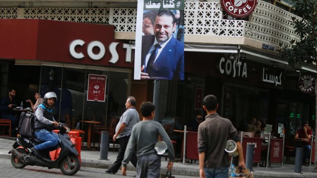 A poster of Saad Hariri with Arabic that reads, "We are all with you," hangs on a street in Beirut, Lebanon on Monday.