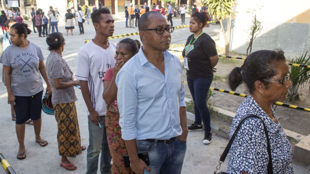 People waiting in line and to cast  their votes in the East Timor parliamentary elections in Dili on Saturday.