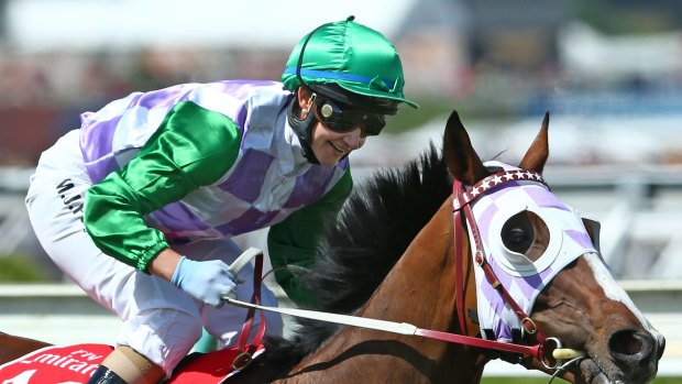 Michelle Payne, riding Prince Of Penzance, smiles after winning the Melbourne Cup.