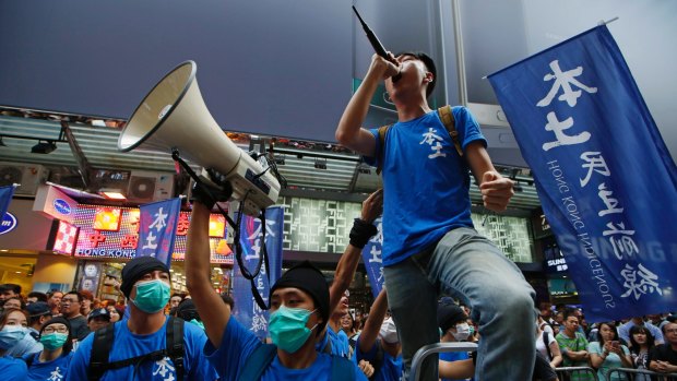 Edward Leung, with microphone, leading a demonstration by the Hong Kong Indigenous party in July 2015.
