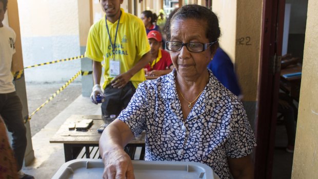 A woman casts her votes in East Timor's parliamentary elections on Saturday.