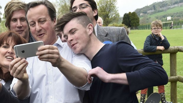 British Prime Minister David Cameron joins supporters for a selfie.