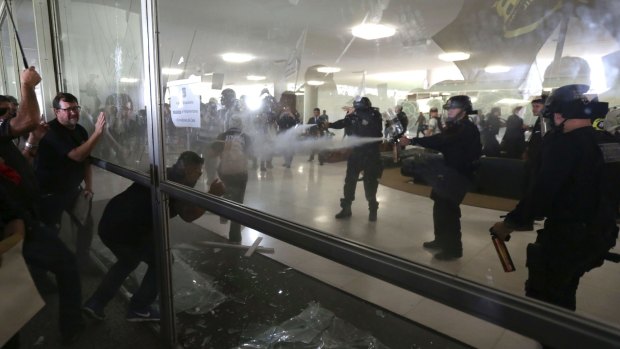 Riot police repel violent demonstrators at the Brazilian Congress on Tuesday.