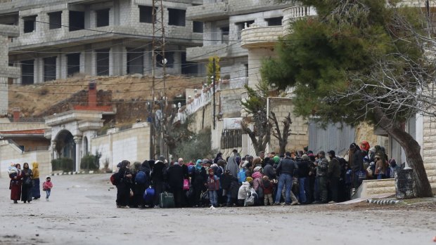 Syrians wait for an aid convoy in Madaya in the countryside of Damascus on Thursday.