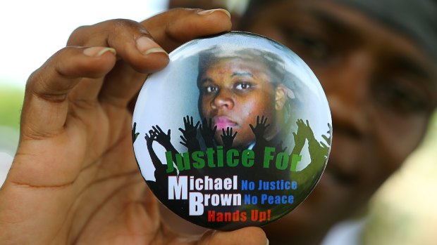 Nikki Jones, of Spanish Lake, Missouri, holds a button in support of Michael Brown.