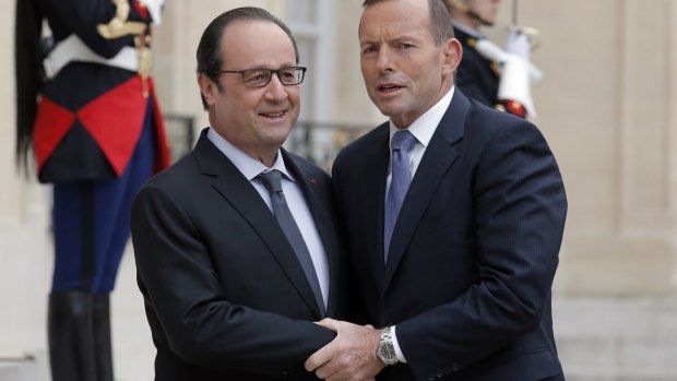 French President Francois Hollande welcomes Prime Minister Tony Abbott to the Elysee Palace, in Paris, on Monday.