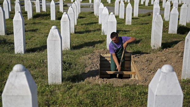 A worker digs graves at a memorial centre for Srebrenica Massacre victims.