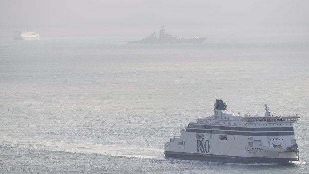 A Russian Naval vessel passes between two car ferries in the English Channel last week.