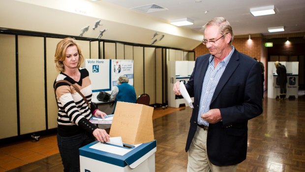 Queanbeyan-Palerang Regional Council administrator Tim Overall, and his wife Nicole submit their vote on election day.