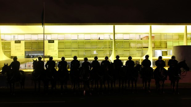 Mounted police guard the Palacio do Planalto, Brazil's seat of government, after protests erupted on Thursday.