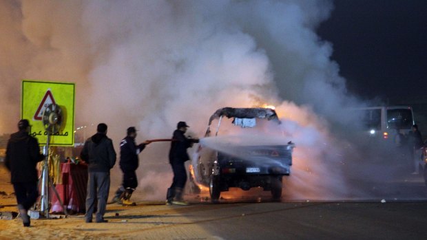 Firefighters try to extinguish a fire on a truck as a riot broke out outside a major football match in Cairo.