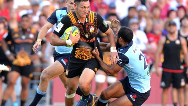Unforgiving conditions: Shaun Stevenson of the Chiefs breaks away from the Waratahs defence.