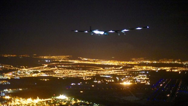 The solar-powered Solar Impulse 2, piloted by Andre Borschberg, approaches Honolulu Airport in Hawaii early on Friday after a record-breaking five-day journey across the Pacific Ocean from Japan.