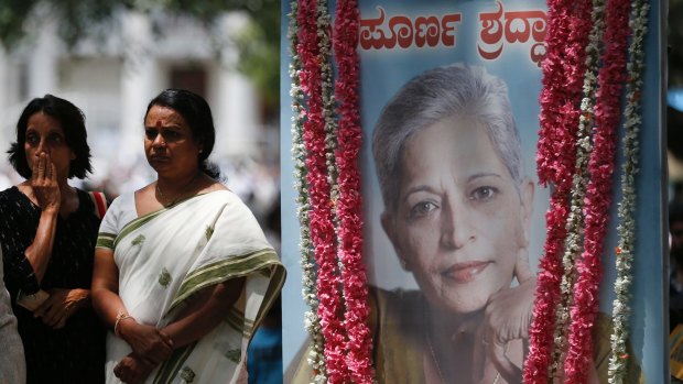 Mourners next to a portrait of Gauri Lankesh during public viewing of her body in Bangalore.