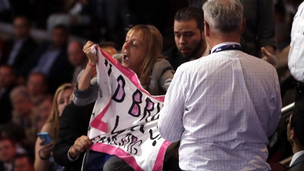 A protester is taken away as  Donald Trump speaks.