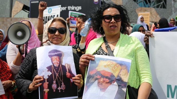 Eritrean-Australian protesters hold up pictures of jailed religious leaders Patriarch Antonios (Christian, jailed since 2007) and Hajji Musa Mohammed Nur (Muslim, arrested October 20). 