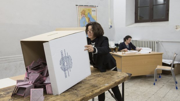 Members of the electoral commission prepare ballot slips for the count after polls closed in Rome on Sunday.