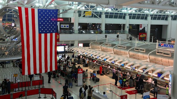 New York: People hurry at Kennedy Airport in New York. 