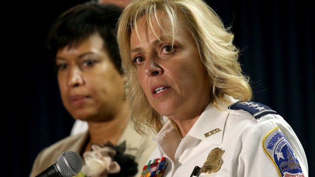 Mayor Muriel Bowser (left) of Washington, DC listens as Chief of the Metropolitan Police Department Cathy Lanier (R) speaks at a press conference at police headquarters to announce the manhunt for Daron Dylon Wint.