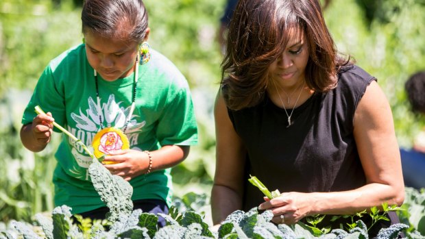 Michelle Obama, joined by school children from across the country, harvests the White House Kitchen Garden in 2016.
