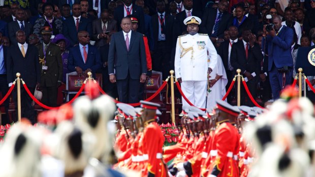 Kenyan President Uhuru Kenyatta and Army Chief of Staff, General Samson Mwathethe, right, watch as armed forces of the Republic of Kenya march, during Kenyatta's inauguration .