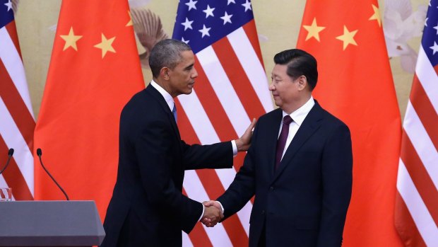 US President Barack Obama shakes hands with Chinese President Xi Jinping last week.