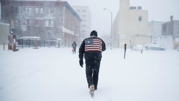 A man pushes his way through driving winds during a winter snowstorm in Atlantic City, New Jersey.