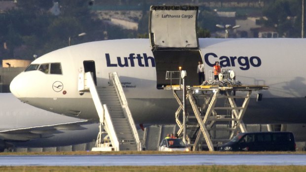 Coffins of the victims are loaded onto a Lufthansa plane at Marseille airport France.