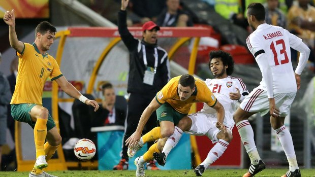Socceroos Tomi Juric and Mathew Leckie scrap for the ball with United Arab Emirates players in the semi-final.