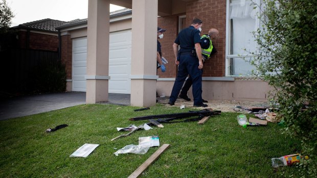 Police inspect the damage to the Point Cook party house. 