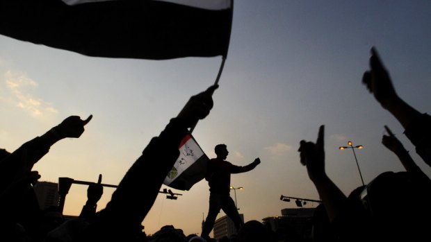 Egyptian protesters wave national flags as they chant slogans against the ruling military council at Tahrir Square, the focal point of Egyptian uprising in Cairo, Egypt, in November 2011.