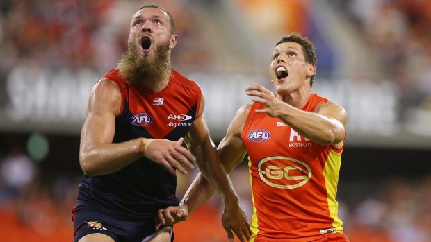 Tunnel vision: Melbourne’s Max Gawn and the Suns’ Daniel Currie compete for the ball. 