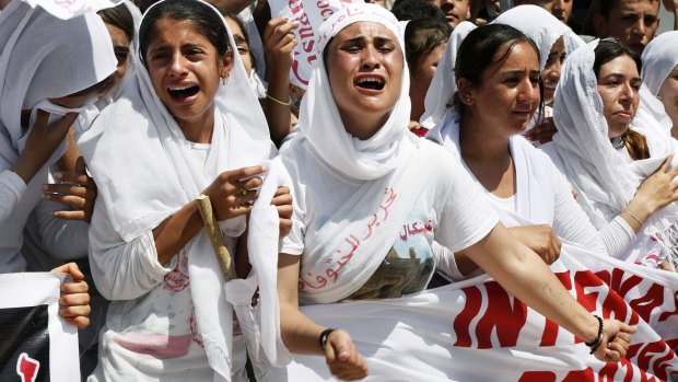 Yazidi women chant slogans in August during a protest on the first anniversary Islamic State's invasion of Sinjar. Thousands of Yazidi women and girls have been sold into sexual slavery and forced to marry IS militants, according to human rights organisations and activists. 