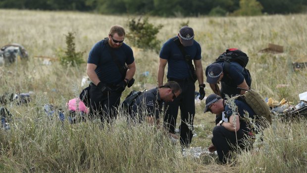 Australian Federal Police officers and their Dutch coutnerparts collect human remains from the MH17 crash site in the fields outside the village of Grabovka in the self-proclaimed Donetsk Republic, Ukraine on August 2, 2014. 