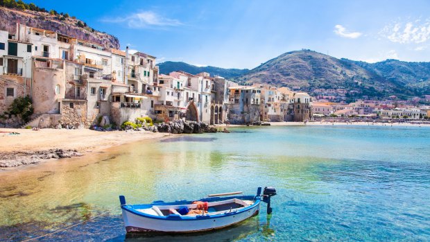 A wooden fishing boat at the beautiful harbour in Cefalu, Sicily.
