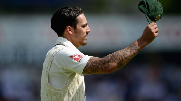 Mitchell Johnson of Australia salutes the crowd after reaching his century of runs conceded.