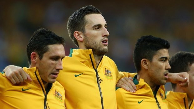 European exit: Socceroo Matthew Spiranovic (centre) leads the defence of Hangzhou Greentown.