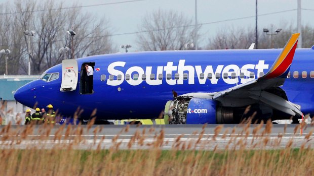 A Southwest Airlines plane sits on the runway at the Philadelphia International Airport after it made an emergency landing in Philadelphia.