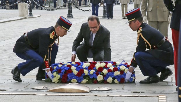 French President Francois Hollande lays a wreath on the tomb of the Unknown Soldier at the Arc de Triomphe.