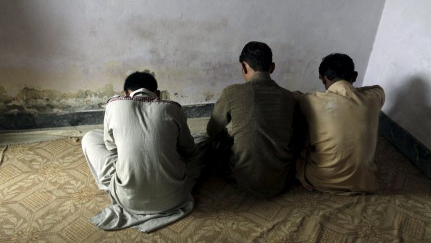 Children who have been sexually abused for internet porn, according to their families, turn their backs to the camera in their village of Husain Khan Wala in Punjab province, the Pakistan prime minister's political heartland. 