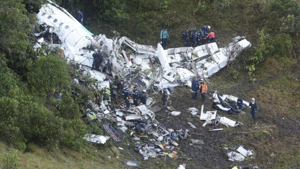 Rescue workers search for survivors at the wreckage site in Colombia.