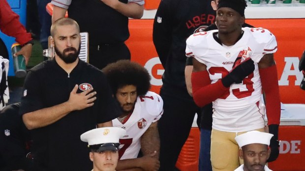 Protest: San Francisco quarterback Colin Kaepernick kneels during the national anthem before the team's NFL preseason game against the San Diego Chargers.