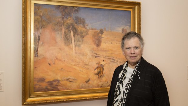 National Gallery of Australia curator Dr Anna Gray with the Tom Robert's painting A break away!