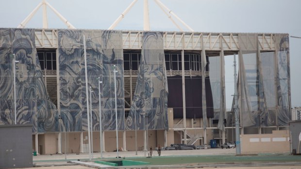 The translucent tapestries created by Brazilian artist Adriana Varejao fall from the exterior of the aquatic stadium in February.